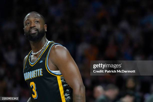 Former Marquette Golden Eagles and NBA player Dwyane Wade shoots during a timeout in the first half of the game against the Providence Friars at...