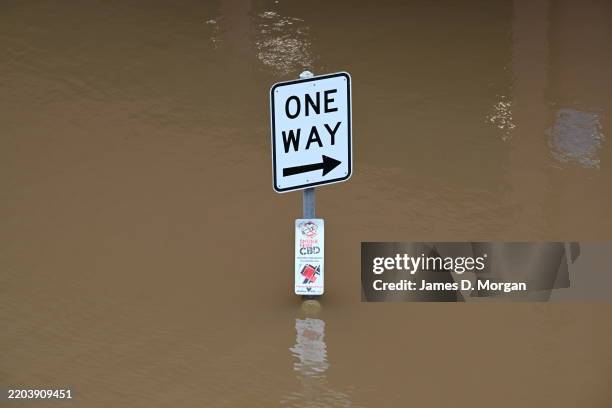 Water flows up to road signs in the CBD on March 08, 2025 in Lismore, Australia. Ex-Cyclone Alfred has now been downgraded to a tropical low but...