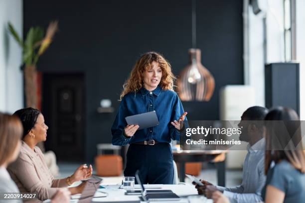 business professional leading team presentation in modern office setting - leader stock pictures, royalty-free photos & images
