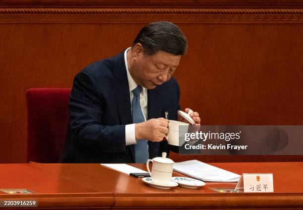Chinese President Xi Jinping drinks tea at the second plenary session of the National Peoples Congress, or NPC, at the Great Hall of the People on...