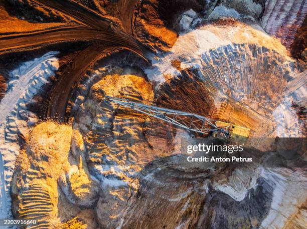 aerial view of the giant excavator in an open pit mine - minería fotografías e imágenes de stock