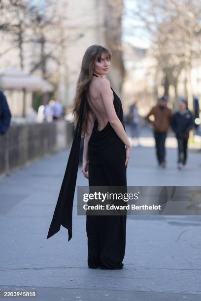 Mara LaFontan wears black halter maxi dress, shiny black pointed toe heels leather shoes, outside Christopher Esber, during the Paris Fashion week...