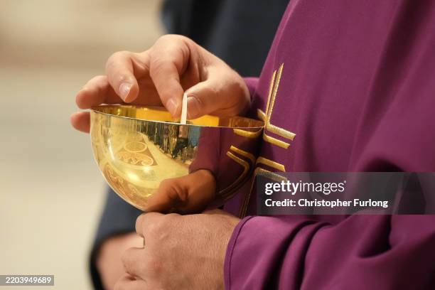 Priest serves communion in St Peter's Basilica as Cardinal Pietro Parolin, the Vatican's Cardinal Secretary of State, conducts a Mass for The...