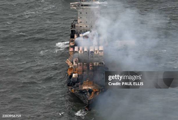 Smoke rises from damaged containers on the deck of the MV Solong cargo ship in the North Sea, off the coast of Withernsea, east of England, on March...