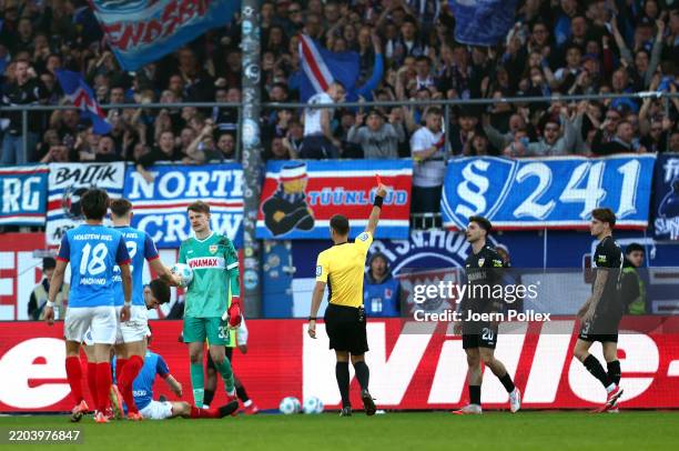 Leonidas Stergiou of VfB Stuttgart receives a red card from Match Referee, Bastian Dankert during the Bundesliga match between Holstein Kiel and VfB...
