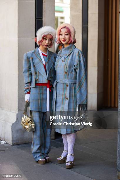 Twins Ami & Aya Amiaya wears fur hat piece, blue checkered coat, cropped blazer, pants, silver bag, golden bag outside Vivienne Westwood during the...