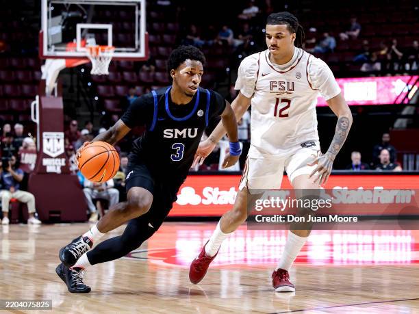 Chuck Harris of the Southern Methodist Mustangs drives to the basket while being defended by Malique Ewin of the Florida State Seminoles during the...