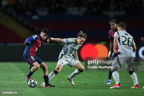 Pedri of FC Barcelona controls the ball while being defended by Andreas Schjelderup and Samuel Dahl of SL Benfica during the Top 16 game of the UEFA...