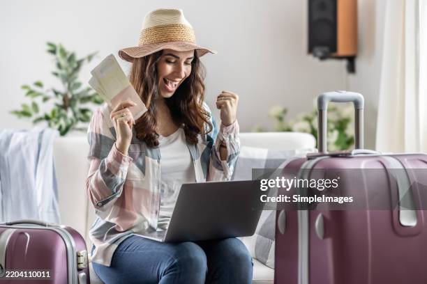 a young traveler is happy with the good price of her booked flight ticket. - fare una prenotazione foto e immagini stock