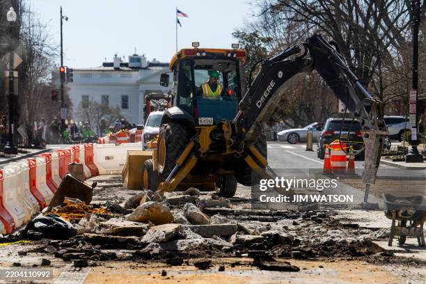 With the White House standing in the background, an excavator jackhammers into Black Lives Matter Plaza in Washington, DC, on March 12, 2025. The...