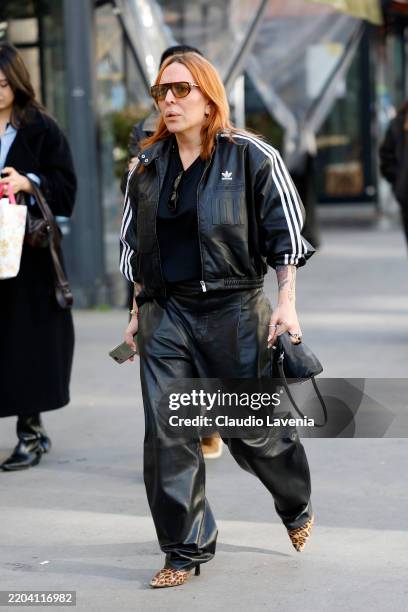 Guest wears black leather Adidas jacket, black leather pants, leopard print heels, black bag, outside Ludovic de Saint Sernin, during the Womenswear...