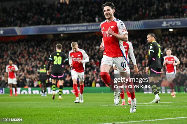 Arsenal's English midfielder Declan Rice celebrates after scoring his team second goal during the last 16 second leg UEFA Champions League football...