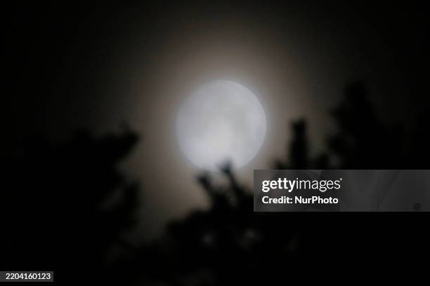 View of the waxing crescent moon is covered with a thick haze of fine dust particles in a country village in Sangju, South Korea, on March 13, 2025....