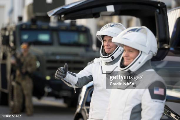 In this NASA handout, NASA astronaut Nichole Ayers gestures to family and friends as her and fellow crewmates NASA astronaut Anne McClain, JAXA...