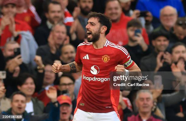 Bruno Fernandes of Manchester United celebrates scoring his team's first goal from a free kickduring the Premier League match between Manchester...