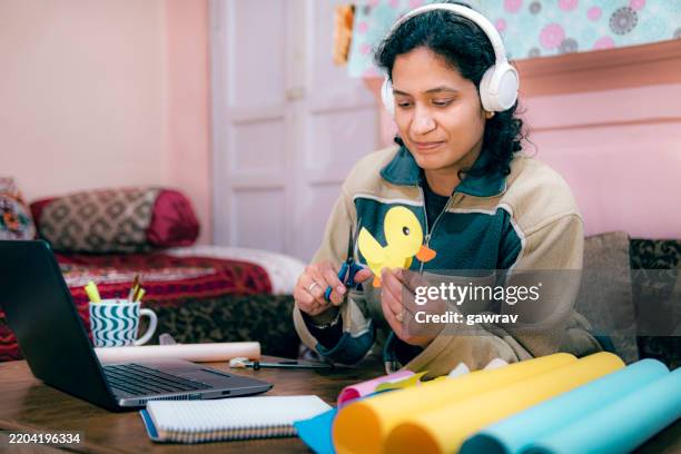 primary school female teacher learns craft skills online to teach students. - hobbies stock pictures, royalty-free photos & images
