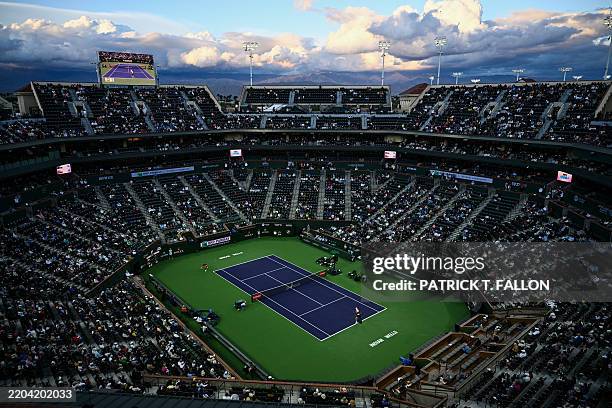 Fans watch as Spain's Carlos Alcaraz and Bulgaria's Grigor Dimitrov play during the Round of 16 men's singles tennis match of the BNP Paribas Open at...