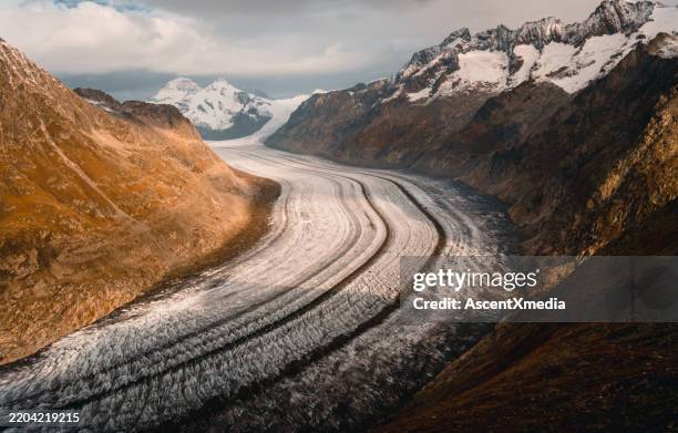 elevated view of glacier and crevasses in valley bottom - aletsch glacier stock pictures, royalty-free photos & images
