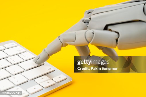 Robotic hand pressing on keyboard computer on yellow background. Robotic hand pressing on keyboard computer on yellow background.
