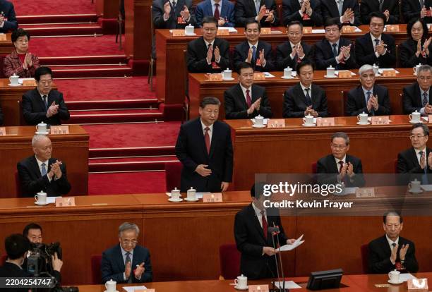 Chinese President Xi Jinping, centre, stands as he is recognized by Standing Committee member and CPPCC Chairman Wang Huning, bottom centre, during...