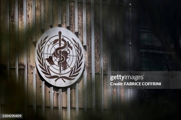 This photograph shows a sign of the World Health Organization displayed at their headquarters in Geneva on March 13, 2025. The Swiss government is...