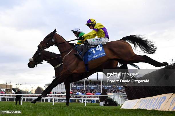 Cheltenham , United Kingdom - 13 March 2025; Jagwar, with Jonjo O'Neill Jr up, left, jumps the last ahead of Thecompanysergeant, with Conor...