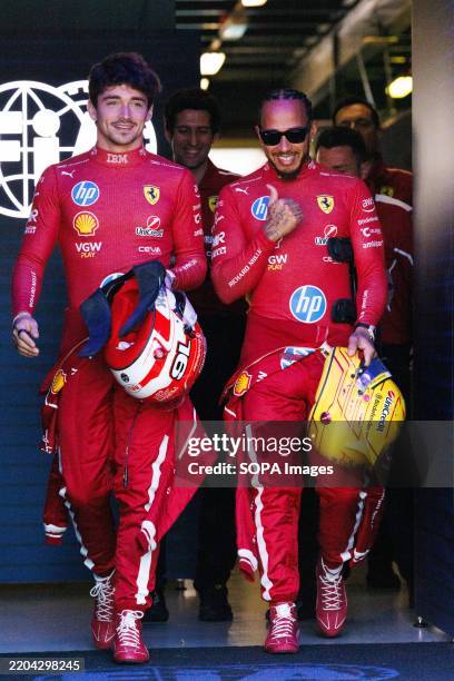 Charles Leclerc of Monaco and the Scuderia Ferrari HP Team and Lewis Hamilton of Great Britain in the paddock ahead of the F1 Grand Prix of Australia...