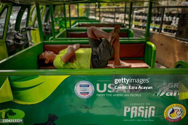 The USAID logo is seen on a broken down electric tricycle at the Pasig Eco Hub, a project impacted by the Trump administration's freeze on foreign...