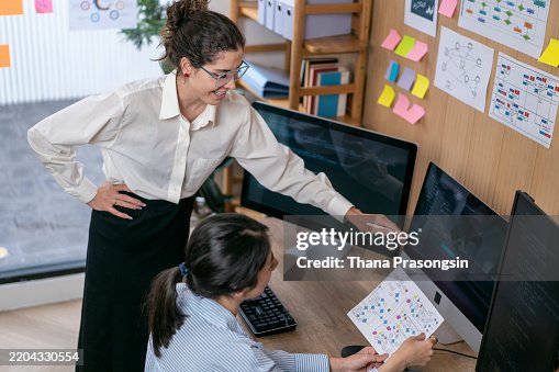 Software programmers analyzing html code and database, brainstorming script ideas to develop new security system. Software programmers analyzing html code and database, brainstorming script ideas to develop new security system.