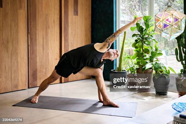 Dynamic Exercise Triangle Yoga Practitioner Doing Triangle Position On Exercise Mat High-Res ...