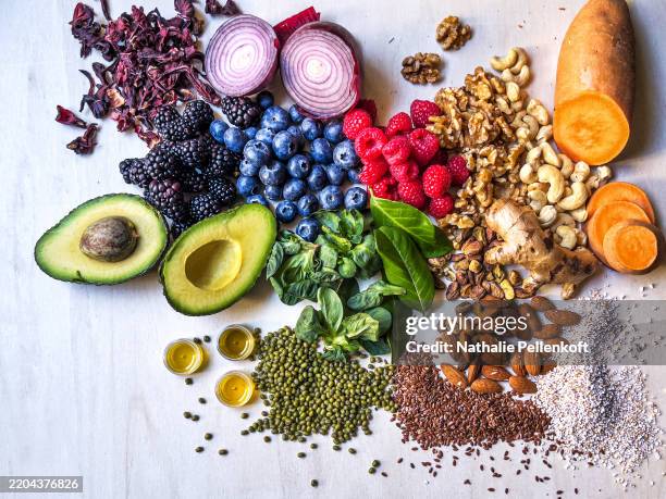 légumes, fruits, légumineuses et noix multicolores sur une table en bois - hygiène alimentaire photos et images de collection
