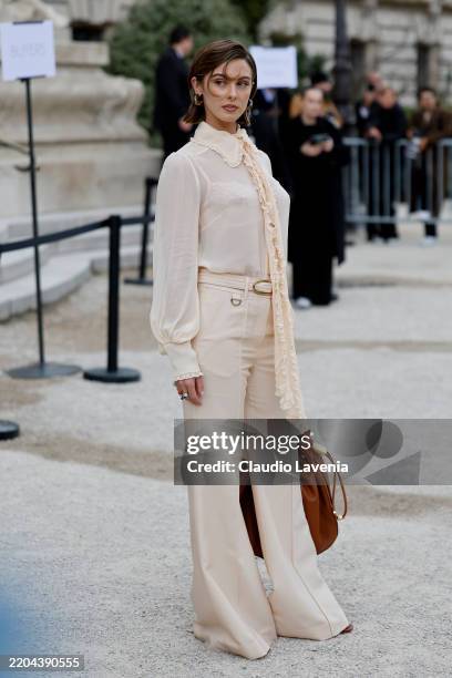 Carmella Rose wears beige blouse, beige trousers, brown bag, outside Zimmermann, during the Womenswear Fall/Winter 2025/2026 as part of Paris Fashion...