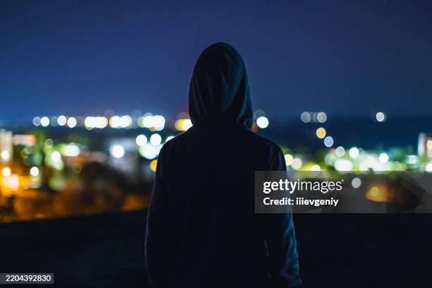 man silhouette at night city background - suicide scene stock pictures, royalty-free photos & images