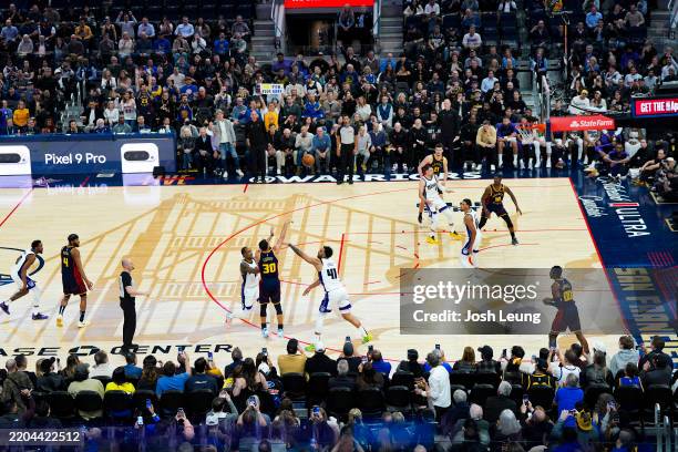 Stephen Curry of the Golden State Warriors shoots a three point basket to become the first player with 4,000 made three-pointers during the game...