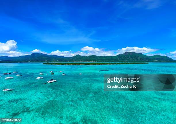 aerial view of large turquoise lagoon and tropical island - mascarene islands stock pictures, royalty-free photos & images