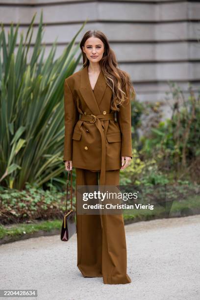 Victoria Magrath wears brown belted blazer, matching pants, bag outside Zimmermann during the Womenswear Fall/Winter 2025/2026 as part of Paris...