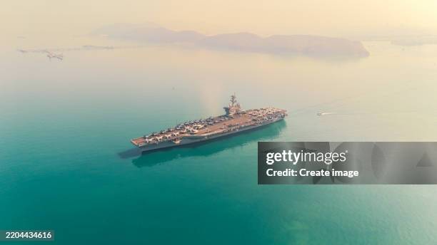 aerial view aircraft carrier on the sea. - military ship stock pictures, royalty-free photos & images