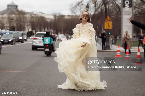 Violet Grace wears pale yellow ruffled dress, boots, sunglasses outside the Zimmermann fashion show during the Womenswear Fall/Winter 2025/2026 as...
