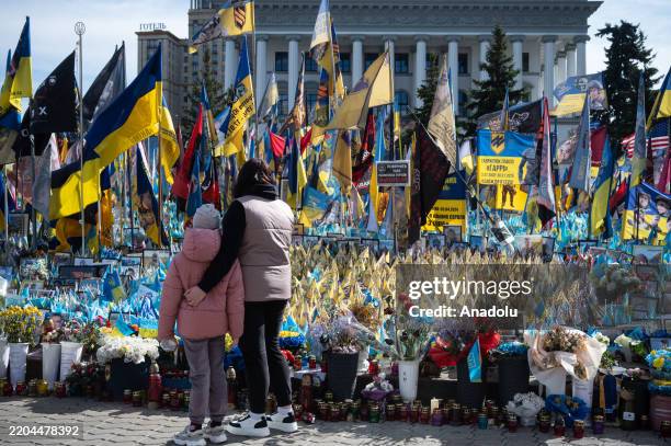Citizens looks at the flags of Ukraine, the United States and others at Independence square during the commemoration ceremony for the 6 Americans,...