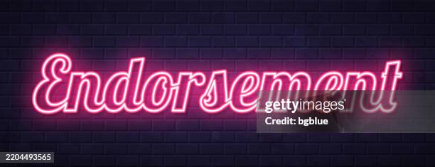 endorsement - glowing neon text on brick wall background - creative writing wall stock illustrations
