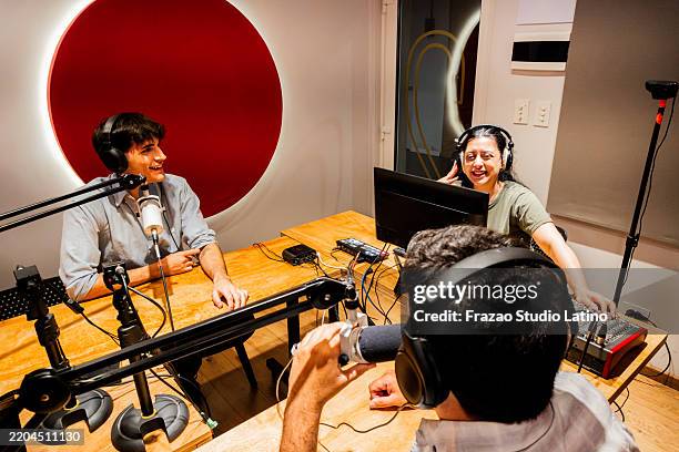 people talking during a podcast at studio - radio show stock pictures, royalty-free photos & images
