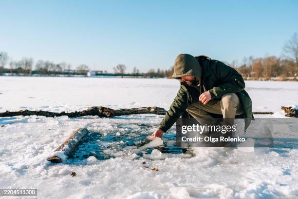 scientist taking water samples from a frozen lake for research - collection stock pictures, royalty-free photos & images