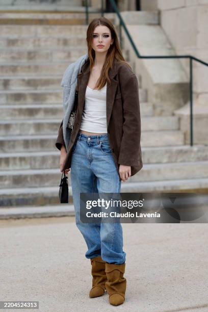 Stella Hanan wears white top, brown blazer, blue jeans, brown suede boots, outside Chanel, during the Womenswear Fall/Winter 2025/2026 as part of...