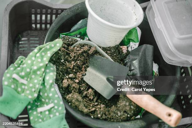 top down image of gardening gloves, spade and soil ready for potting plants - garden trowel stock pictures, royalty-free photos & images