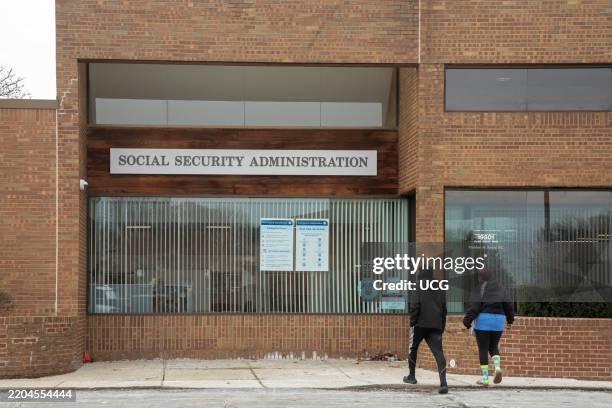 St Clair Shores, Michigan, Two people enter a Social Security Administration office in suburban Detroit.