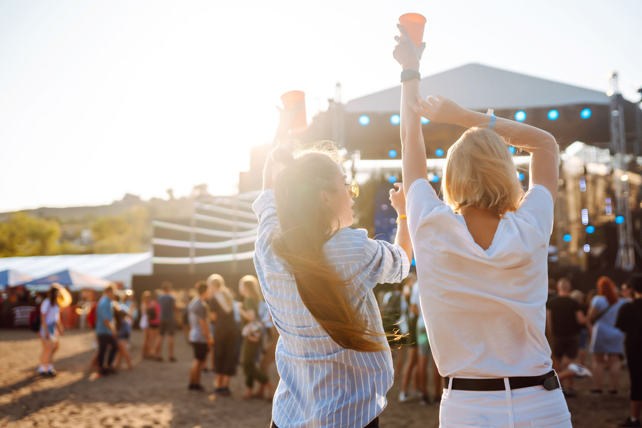 Happy women having fun at a music festival with beer in their hands. Happy women having fun at a music festival with beer in their hands.