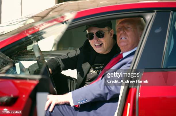 President Donald Trump and White House Senior Advisor, Tesla and SpaceX CEO Elon Musk sit in a Model S on the South Lawn of the White House on March...
