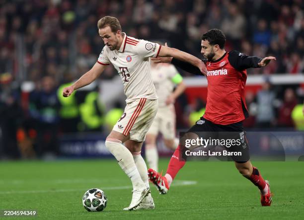 Harry Kane of Bayern Munich holds off the challenge of Mario Hermoso of Bayer 04 Leverkusen during the UEFA Champions League 2024/25 Round of 16...
