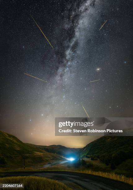 perseid meteor shower over scotland - meteor shower stock pictures, royalty-free photos & images