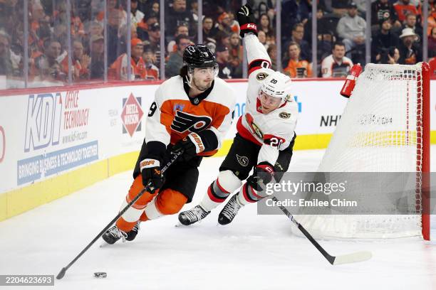 Jamie Drysdale of the Philadelphia Flyers controls the puck against Fabian Zetterlund of the Ottawa Senators during the first period at the Wells...
